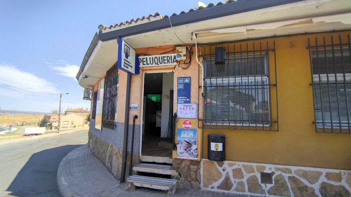 Un cartel anuncia el número premiado en la Peluquería Modes en Solosancho.